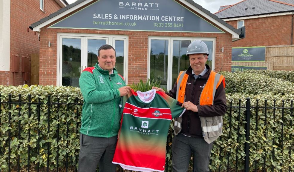 Daniel Mountstevens (Teignbridge Trojans player, left) and Paul Stubbs (Victoria Heights site manager, right) unveil the new shirt outside the Victoria Heights sales and information centre