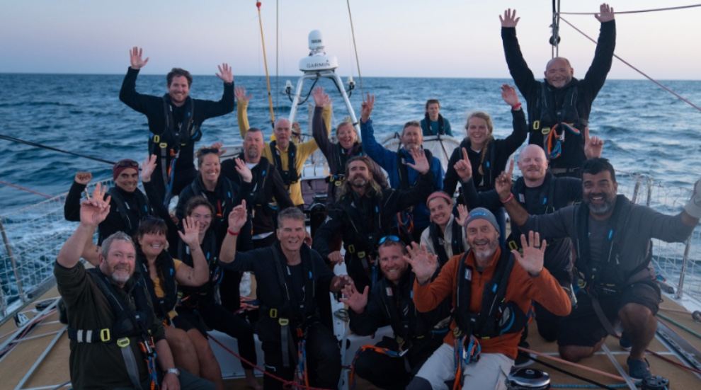 Bob Beggs (front, far left) and his team celebrate on board.