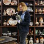 Auctioneer studying Asian art