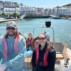 A family on a boat leaving harbour