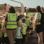 School children stood with teachers and construction director at Coln Signature Homes building site