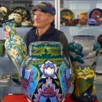 Auctioneer with examples of Moorcroft Pottery