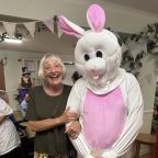 L-R Community visitor Pam Martin with the White Rabbit, aka Adam Stratton, healthcare assistant
