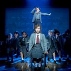 Matilda on stage with cast in background