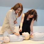 Delegates practising CPR techniques during an accredited first aid training course