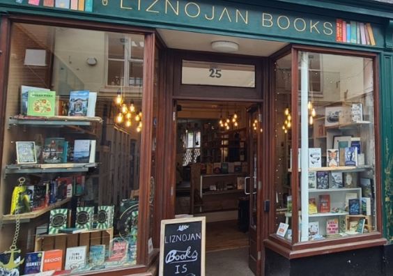 Bookshop with books in the window and two women standing outside
