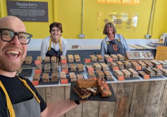 Flapjackery's Oli Robbins with Judith Quinn and Philippa Ryan celebrate Taste of the West Gold