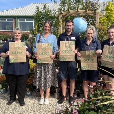 Group of people holding paper bags