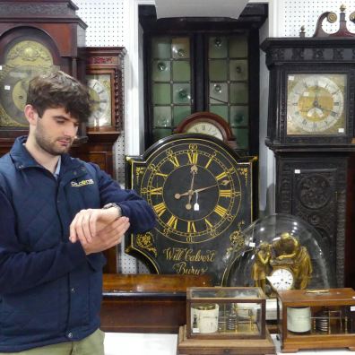 Chilcotts Auctioneer Barnaby Willis with some of the clocks