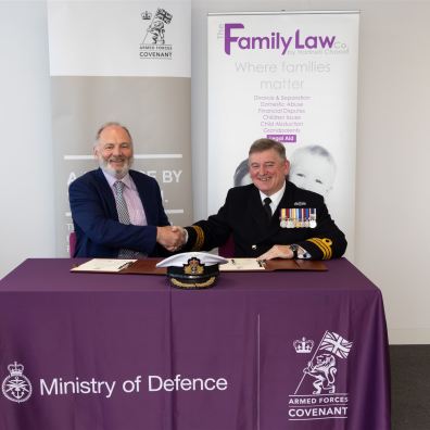 Handshake between law firm Director and Commander Stephen Henaghen