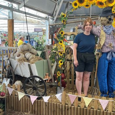 Woman with a scarecrow at Otter Gaden Centres