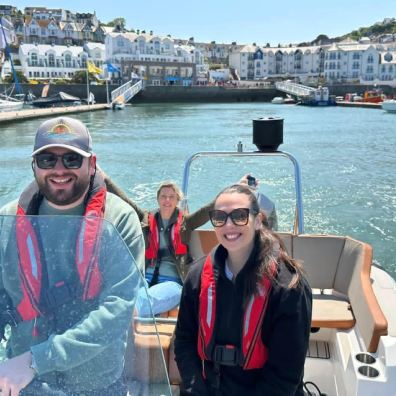 A family on a boat leaving harbour