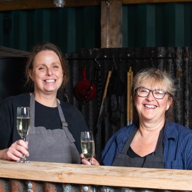 Two women enjoying a glass of fizz