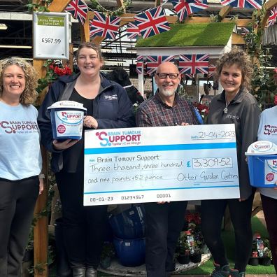 People holding a  giant cheque for Brain Tumour Support