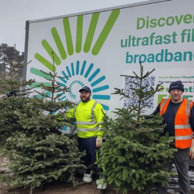 Jurassic Fibre Hospiscare employees holding their Xmas trees