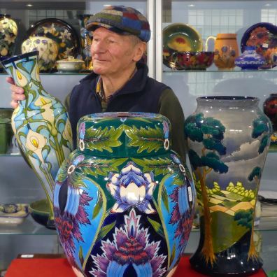 Auctioneer with examples of Moorcroft Pottery