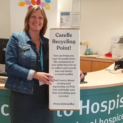 Woman standing in Hospiscare reception with candle collection point