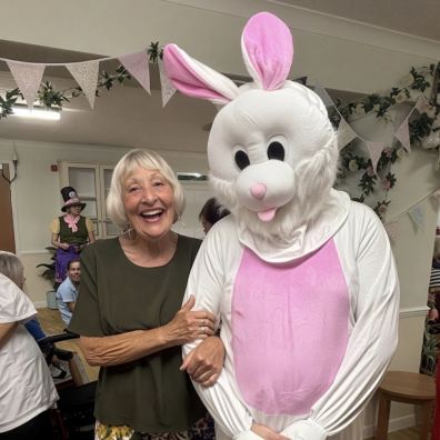 L-R Community visitor Pam Martin with the White Rabbit, aka Adam Stratton, healthcare assistant