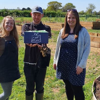 Handing over the box of seeds