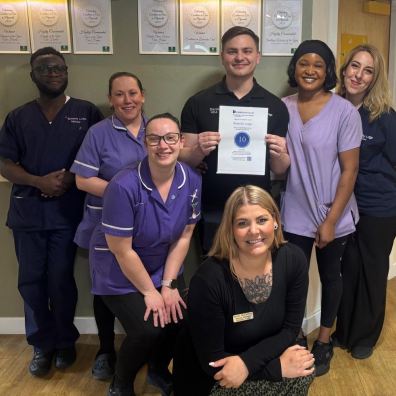 Butterfly Lodge team members with their top score certificate