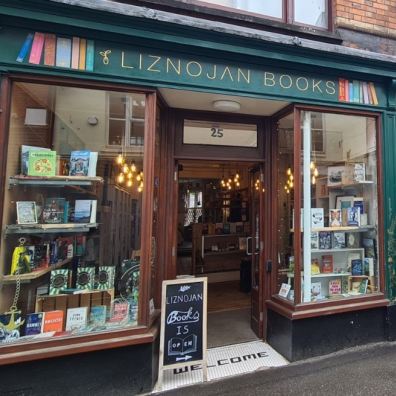 Bookshop with books in the window and two women standing outside