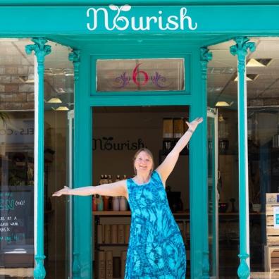 Woman standing outside shop