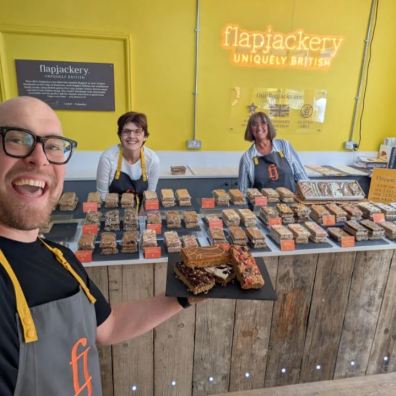Flapjackery's Oli Robbins with Judith Quinn and Philippa Ryan celebrate Taste of the West Gold