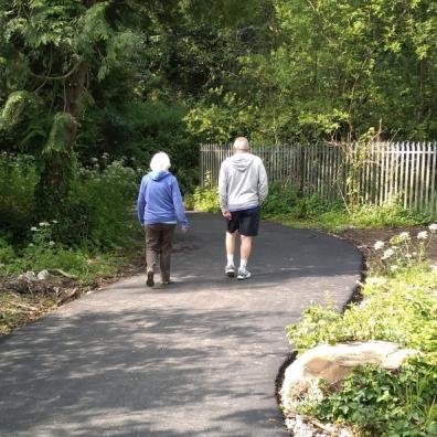 Couple walking along traffic-free pth