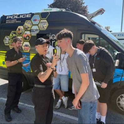 Teen using a breathalyser with the police