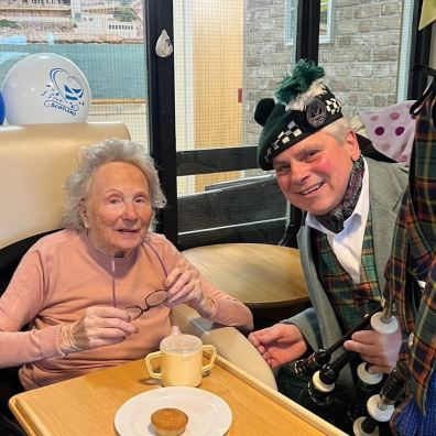 Butterfly Lodge resident Audrey with Dave The Lone Piper