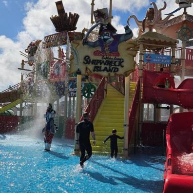 Boy and father at pirate waterpark play structure, Splashdown Quaywest