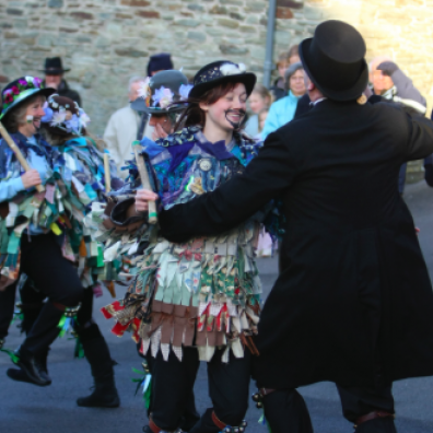 Father Christmas plays a tune for the Morris dancers Credit: National Trust