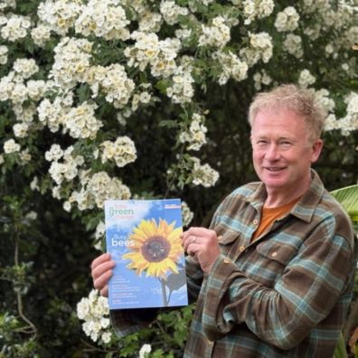 Toby Buckland holding an eco magazine
