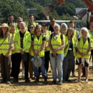 Building team stood on land in hi vis jackets