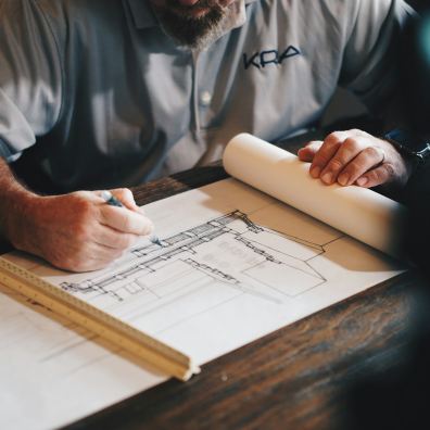 Architect reviewing a site drainage plan on a desk