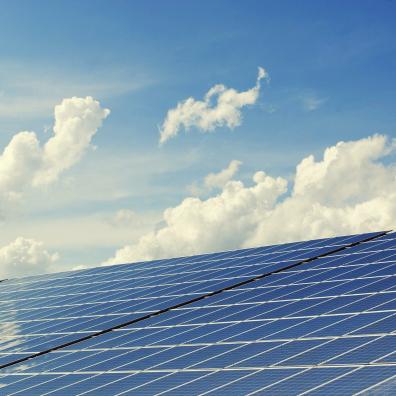 A bank of solar panels against the sky