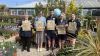 Group of people holding paper bags