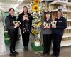 Group of people holding sunflower seed packets