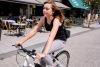 Woman cycling on high street that has been closed to motor traffic