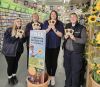 Group of garden centre workers with free seed packets