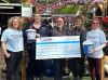 People holding a  giant cheque for Brain Tumour Support