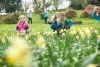 children, running, outside through daffodils in gardens