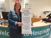 Woman standing in Hospiscare reception with candle collection point