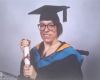 Jen Statterley in graduation outfit holding a scroll