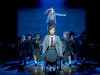Matilda on stage with cast in background
