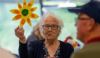 Old lady holding sunflower at library