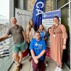 People posing in front of Bishop Fleming, Chestnut Appeal, and Devon Mind branded banners