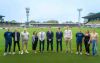 Players, staff and family members gather pitch side at Torquay United to mark recent signings.  