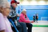 A diverse group of people talking together in a bright community centre