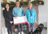 Maria Nolan and Sophie Page present the fundraising cheque to Guide Dogs volunteer Di Hatchett and g